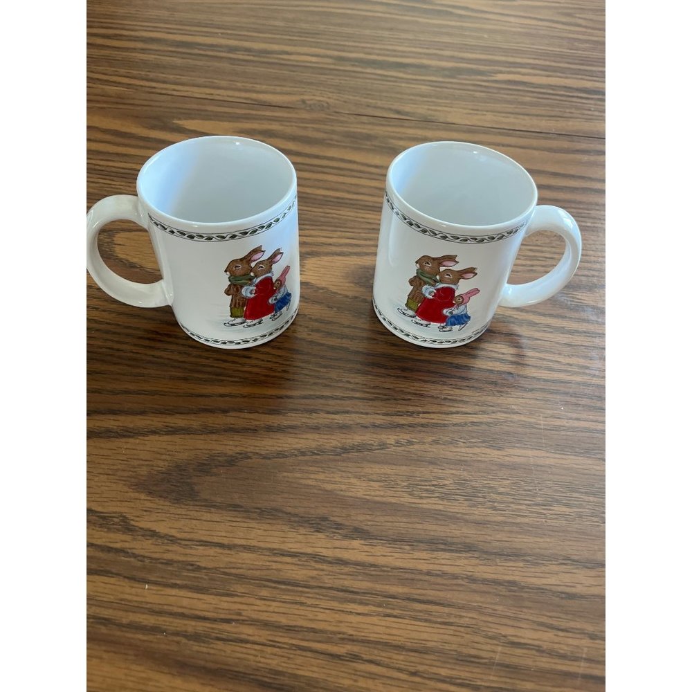 Susan Isbelle white set of two mugs with three bunny rabbits ice skating